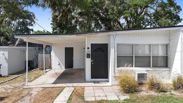 view of front of home featuring ac unit and an attached carport