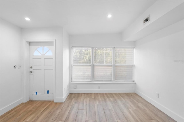 foyer entrance with light wood-type flooring, recessed lighting, baseboards, and visible vents