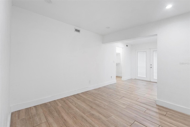empty room featuring baseboards, recessed lighting, visible vents, and light wood-type flooring