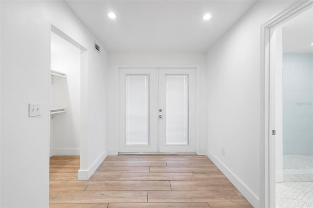 interior space featuring french doors, visible vents, light wood-style flooring, and recessed lighting