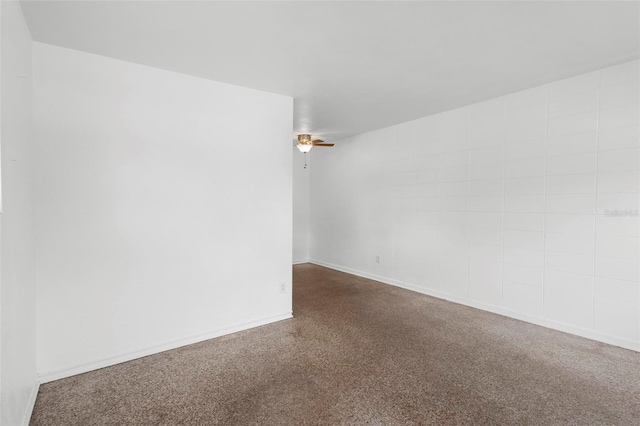 unfurnished room with baseboards and a ceiling fan