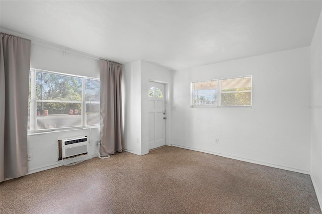 empty room with a wall mounted air conditioner and a healthy amount of sunlight