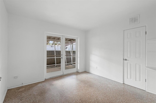 unfurnished room featuring baseboards, french doors, and visible vents