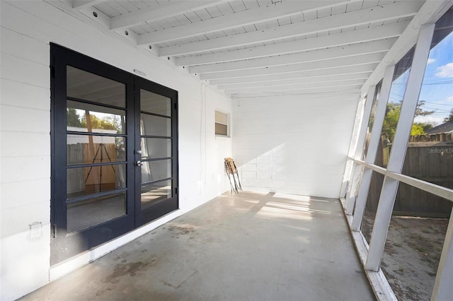 unfurnished sunroom featuring french doors and beam ceiling