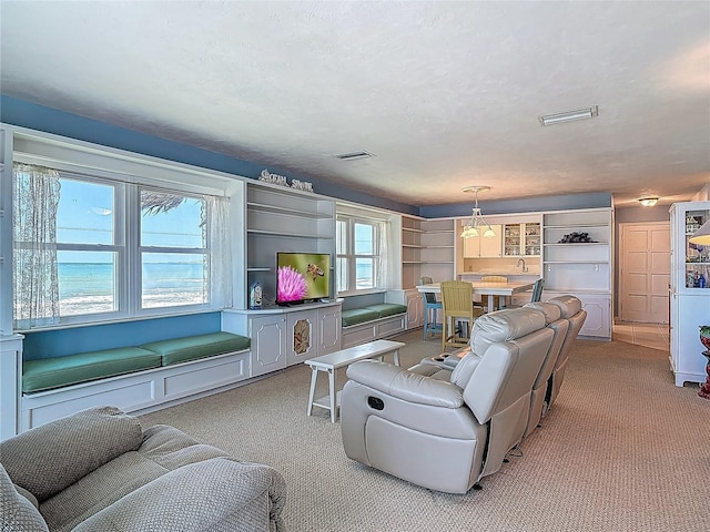 living room with visible vents and carpet
