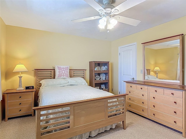 bedroom featuring ceiling fan and light carpet