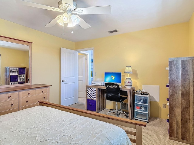 carpeted bedroom with a ceiling fan and visible vents