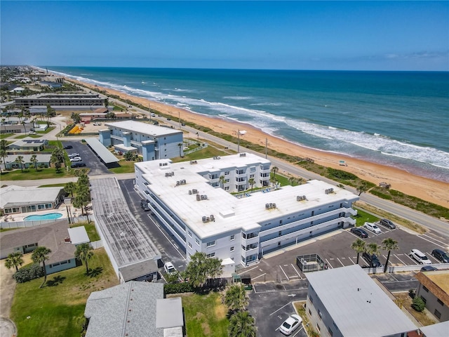 birds eye view of property with a beach view and a water view