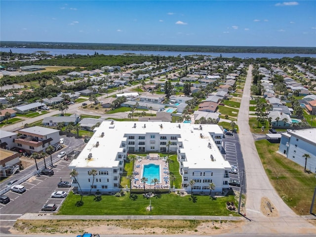 birds eye view of property with a water view and a residential view