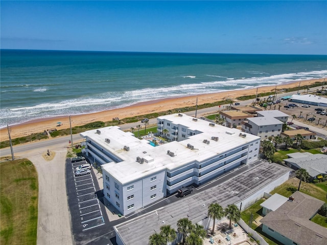 drone / aerial view with a water view and a view of the beach