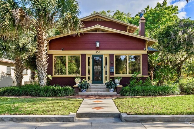 806 E Amelia St, Orlando, FL 32803 - view of front of home featuring a front lawn and a chimney