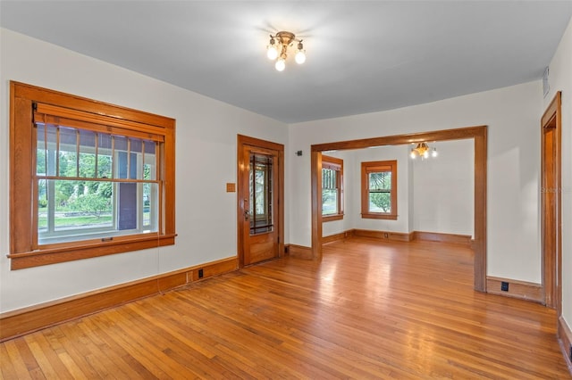 806 E Amelia St, Orlando, FL 32803 - spare room featuring baseboards, visible vents, light wood-style flooring, and a chandelier