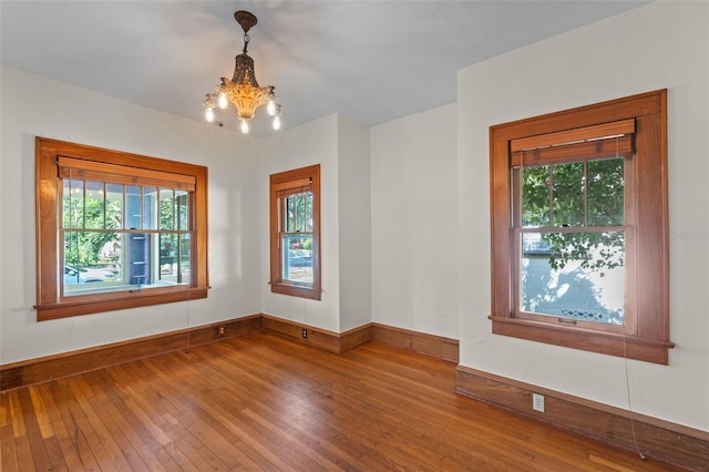 806 E Amelia St, Orlando, FL 32803 - spare room featuring an inviting chandelier, baseboards, hardwood / wood-style floors, and a healthy amount of sunlight