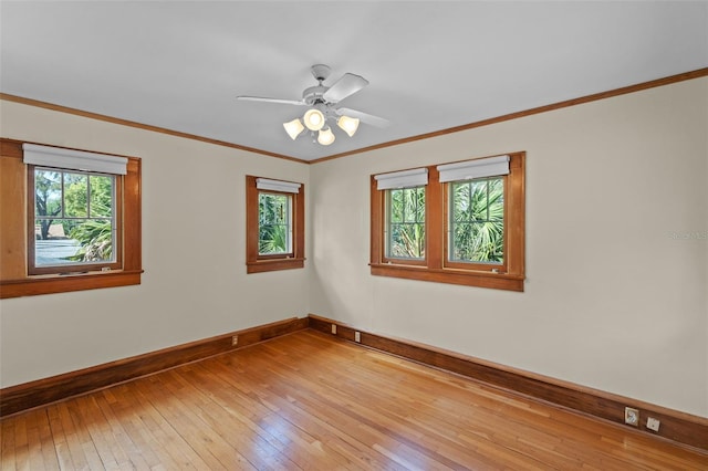 806 E Amelia St, Orlando, FL 32803 - unfurnished room featuring crown molding, baseboards, light wood-style flooring, and a healthy amount of sunlight