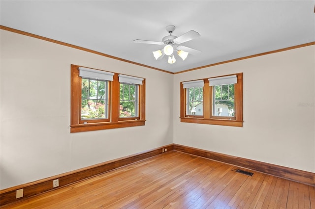 806 E Amelia St, Orlando, FL 32803 - spare room with baseboards, light wood-type flooring, a healthy amount of sunlight, and visible vents