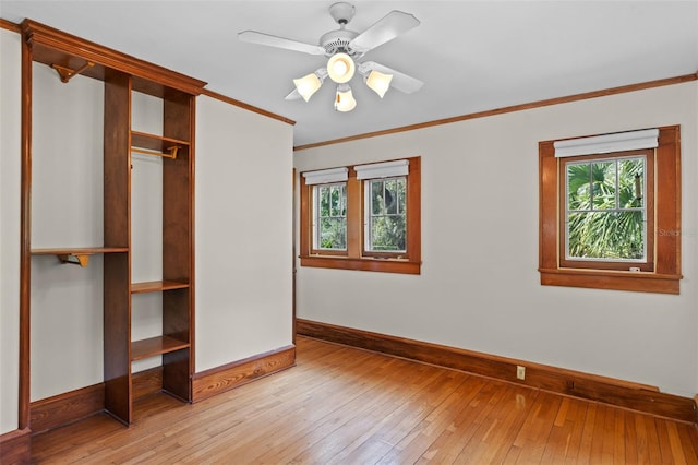 806 E Amelia St, Orlando, FL 32803 - unfurnished bedroom with baseboards, light wood-style floors, a closet, and crown molding