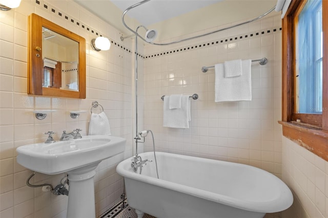 806 E Amelia St, Orlando, FL 32803 - bathroom featuring a soaking tub, tile walls, and a shower