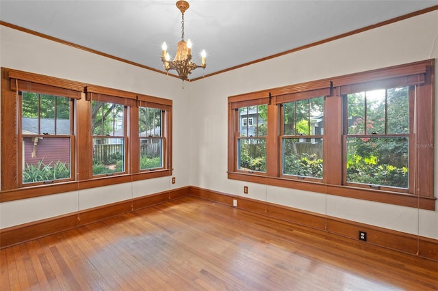 806 E Amelia St, Orlando, FL 32803 - spare room featuring an inviting chandelier, baseboards, ornamental molding, and hardwood / wood-style flooring