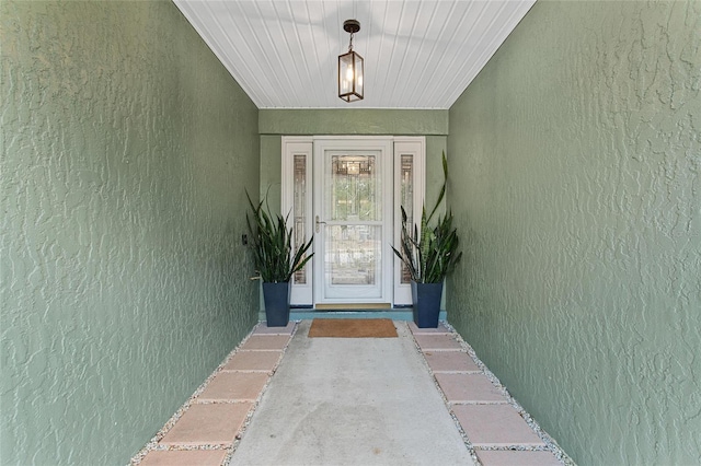 property entrance with stucco siding