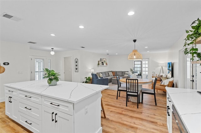 kitchen featuring visible vents, recessed lighting, light wood-style flooring, and white cabinetry