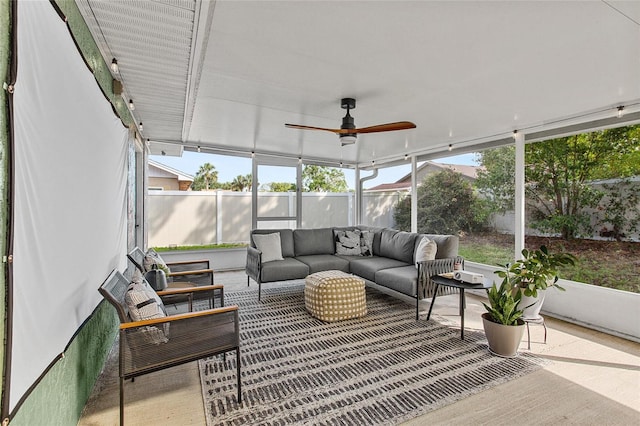 sunroom featuring ceiling fan, plenty of natural light, and an outdoor hangout area