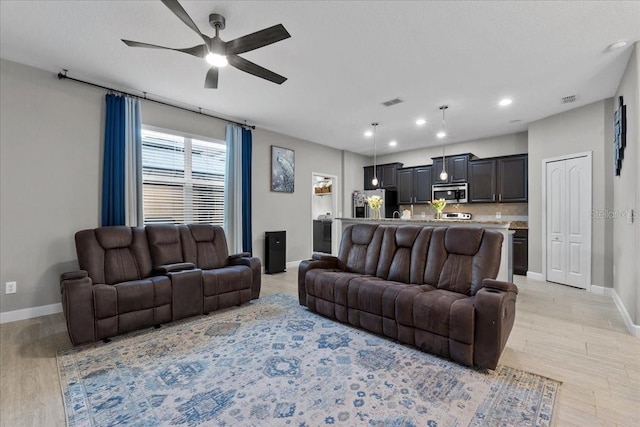 9009 Savannah Julip Ln, Orlando, FL 32832 - living room with ceiling fan, baseboards, light wood-type flooring, and recessed lighting