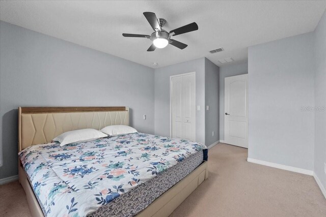9009 Savannah Julip Ln, Orlando, FL 32832 - bedroom with light carpet, baseboards, a closet, and ceiling fan
