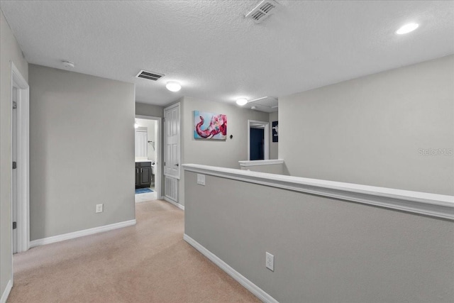 9009 Savannah Julip Ln, Orlando, FL 32832 - corridor with baseboards, light colored carpet, a textured ceiling, and an upstairs landing