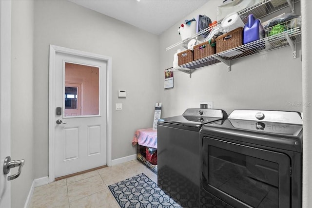 9009 Savannah Julip Ln, Orlando, FL 32832 - washroom featuring washing machine and dryer, baseboards, and light tile patterned floors