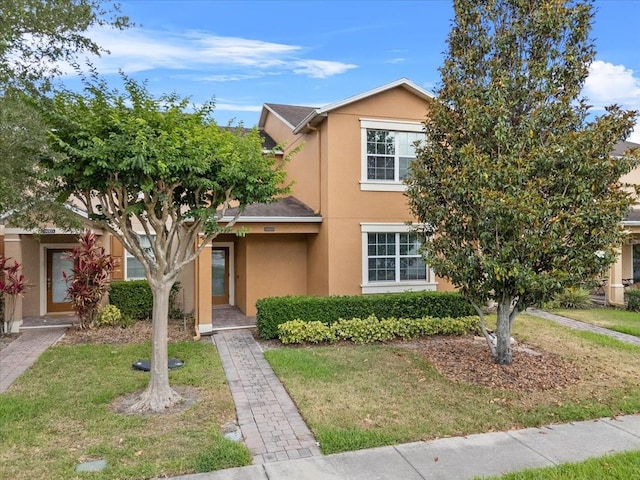9009 Savannah Julip Ln, Orlando, FL 32832 - view of front of property featuring stucco siding and a front lawn