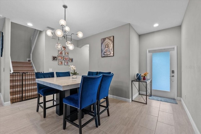 9009 Savannah Julip Ln, Orlando, FL 32832 - dining room featuring arched walkways, stairs, baseboards, light wood finished floors, and recessed lighting