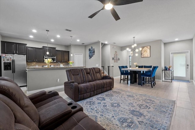 9009 Savannah Julip Ln, Orlando, FL 32832 - living room with recessed lighting, a ceiling fan, a chandelier, light wood-style flooring, and baseboards
