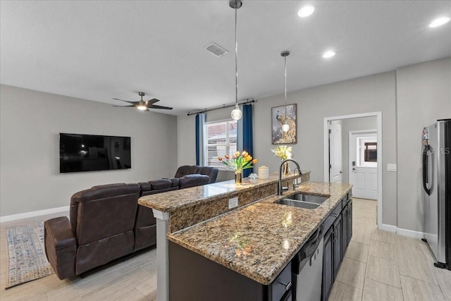9009 Savannah Julip Ln, Orlando, FL 32832 - kitchen with a sink, stainless steel appliances, baseboards, decorative light fixtures, and a ceiling fan