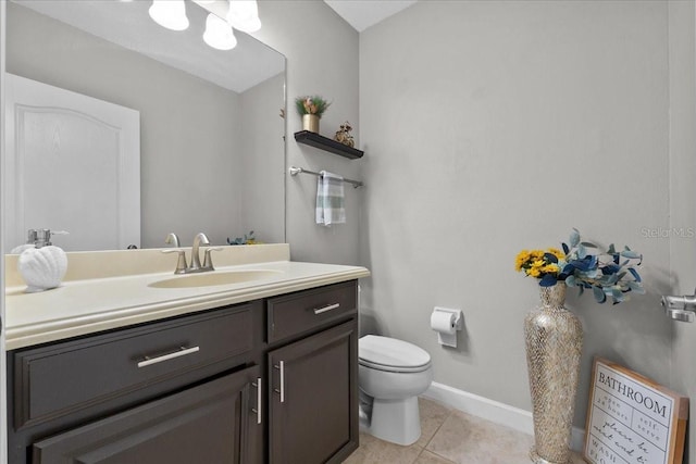 9009 Savannah Julip Ln, Orlando, FL 32832 - half bathroom featuring tile patterned flooring, vanity, toilet, and baseboards