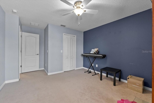 9009 Savannah Julip Ln, Orlando, FL 32832 - carpeted bedroom featuring a closet, baseboards, a textured ceiling, and ceiling fan