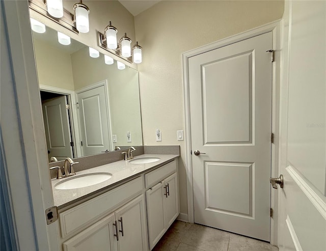 full bath featuring a sink, tile patterned flooring, and double vanity