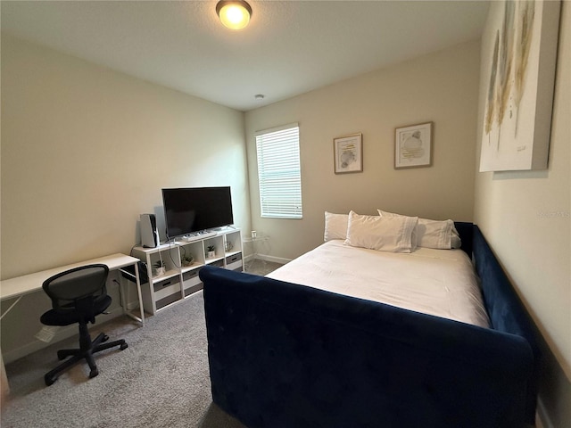 bedroom featuring carpet floors and baseboards