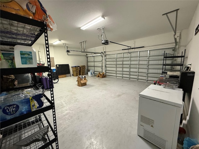 garage featuring washer / dryer and a garage door opener