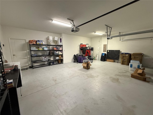 garage featuring a garage door opener and electric panel