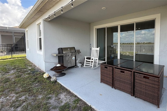 view of patio featuring area for grilling and fence