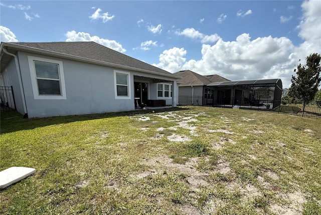 rear view of house with a fenced backyard, stucco siding, and a yard