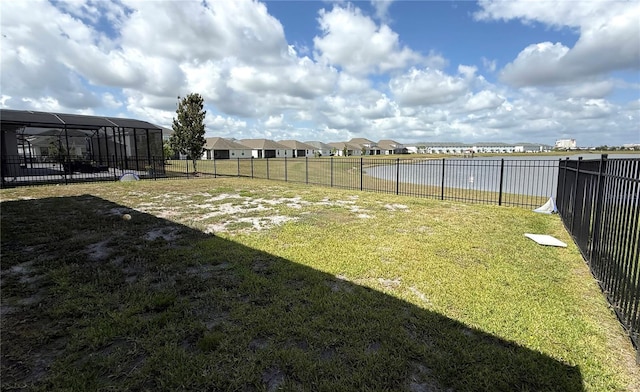 view of yard featuring a water view and fence