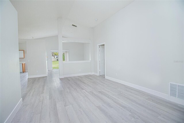 13434 Mallard Cove Blvd, Orlando, FL 32837 - unfurnished living room featuring light wood finished floors, lofted ceiling, and baseboards