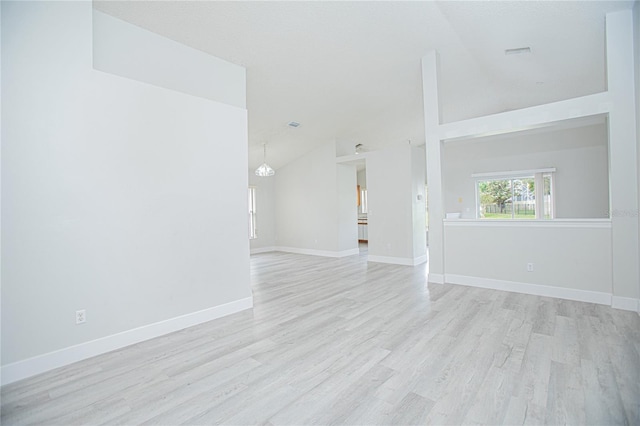 13434 Mallard Cove Blvd, Orlando, FL 32837 - unfurnished living room featuring vaulted ceiling, light wood finished floors, and baseboards