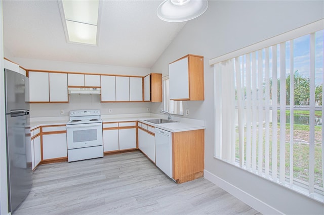 13434 Mallard Cove Blvd, Orlando, FL 32837 - kitchen with white appliances, a sink, light countertops, light wood-style flooring, and vaulted ceiling