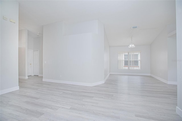 13434 Mallard Cove Blvd, Orlando, FL 32837 - unfurnished room with light wood-type flooring, a chandelier, baseboards, and lofted ceiling