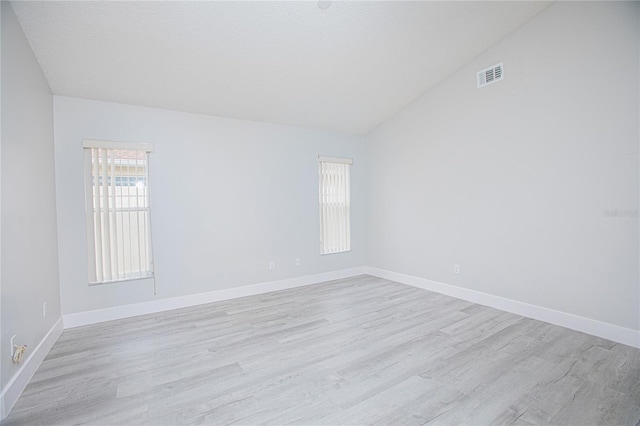 13434 Mallard Cove Blvd, Orlando, FL 32837 - unfurnished room with vaulted ceiling, light wood-style flooring, and baseboards