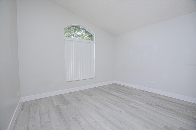 13434 Mallard Cove Blvd, Orlando, FL 32837 - unfurnished room featuring wood finished floors, vaulted ceiling, and baseboards