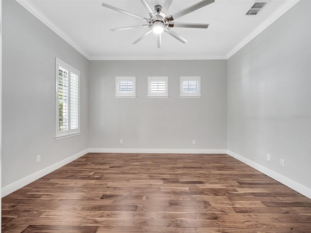 unfurnished room featuring a ceiling fan, visible vents, ornamental molding, and wood finished floors
