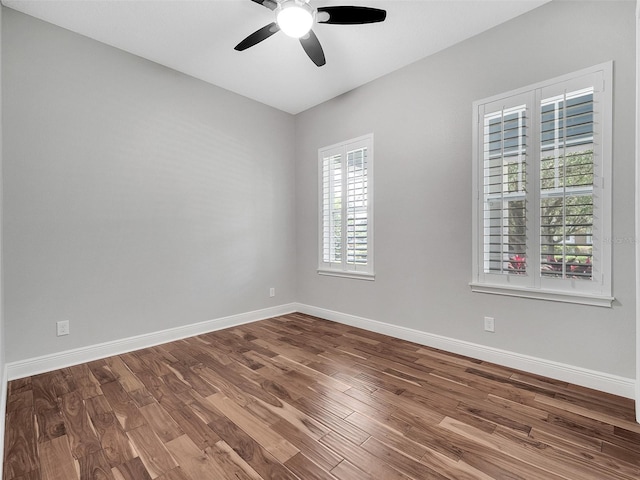 empty room featuring baseboards, a ceiling fan, and wood finished floors